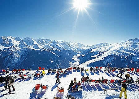 Illustrating far infrared and human comfort. Skiers bathing in the sun's infrared.