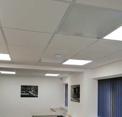 Herschel white panels ceiling mounted in office space